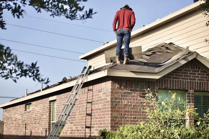 Professional roofer working on a residential roof in Newman